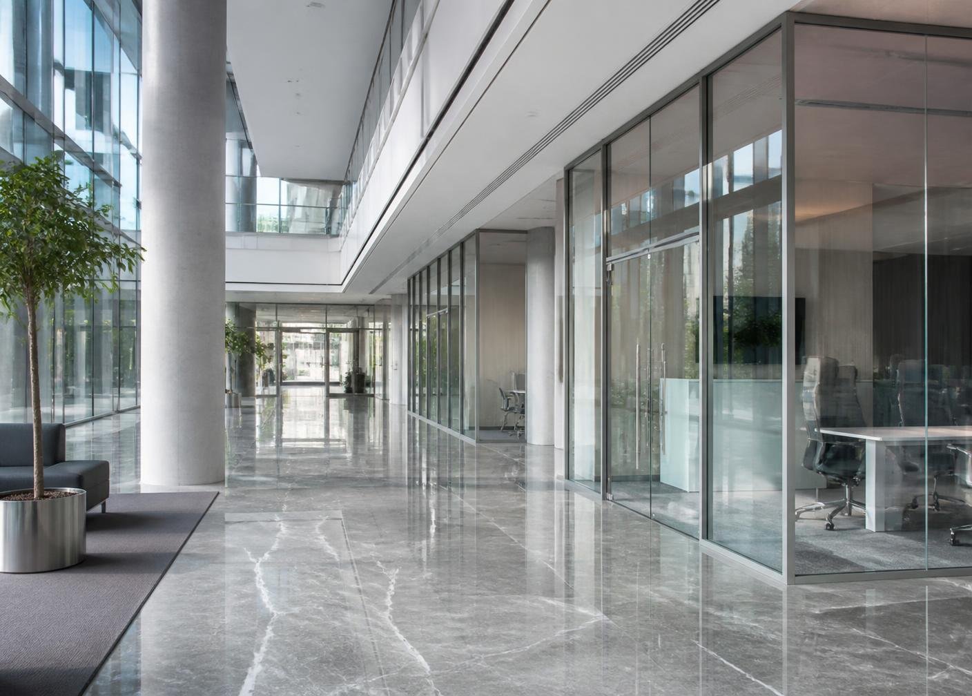Modern commercial lobby with glass cabins and aluminium glazing
